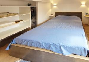 a bedroom with a large bed and white shelves at Le clos du prieuré - Les Gîtes de la Côte d'Amour in Batz-sur-Mer +19 photos
