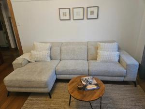 a living room with a couch and a coffee table at Renovated 1930's home in Sandy Bay