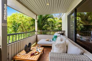 una veranda protetta con un divano e un tavolo di Ekolu 911 a Wailea