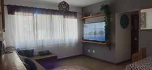 a living room with a flat screen tv on a wall at Home 013 in São Vicente