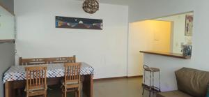 a living room with a table and chairs and a couch at Home 013 in São Vicente