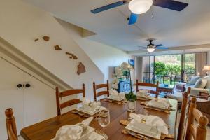 a dining room with a wooden table and chairs at Kahana Villa E111 in Kahana