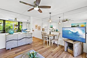 a living room with a ceiling fan and a dining room at Paki Maui 319 in Honokowai +21 photos