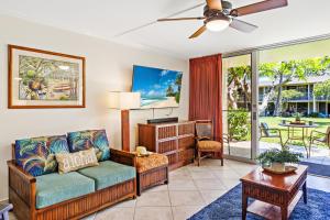 a living room with a couch and a table at Napili Shores F150 in Kapalua +18 photos