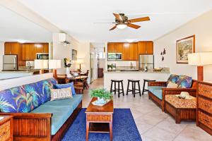 a living room with a couch and a kitchen at Napili Shores F150 in Kapalua