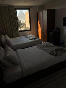 Postel nebo postele na pokoji v ubytování Prince PyraMids & Sphinx + 41 fotografií