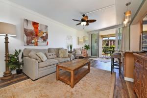 a living room with a couch and a table at Hale Ono Loa 203 in Kahana
