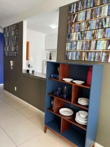 a book shelf with plates on it in a kitchen at LK Santo Antônio 1 in Belo Horizonte +47 photos