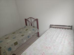 two twin beds in a room with at Casa simples e aconchegante em Poços de caldas in Poços de Caldas