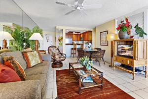 a living room with a couch and a table at Hololani A203 in Kahana