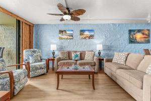 a living room with a couch and a table at Kanai A Nalu 202 in Wailuku