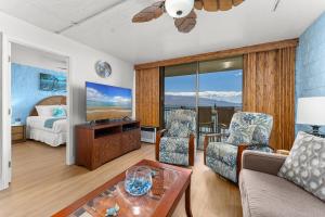 a living room with a couch and a table at Kanai A Nalu 202 in Wailuku +36 photos