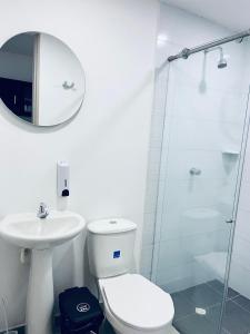 a bathroom with a toilet and a sink and a shower at Habitacion con baño privado cali in Cali