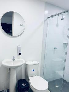a bathroom with a toilet and a sink and a shower at Habitacion con baño privado cali in Cali