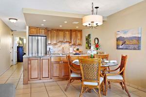 a kitchen and dining room with a table and chairs at Kahana Reef 408 in Kahana
