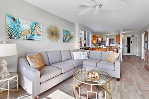a living room with a couch and a table at Kahana Manor 619 in Kahana