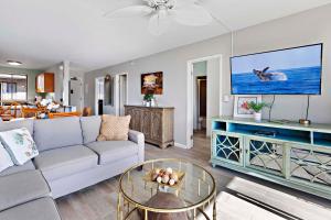 a living room with a couch and a table at Kahana Manor 619 in Kahana