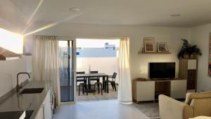 a living room with a kitchen and a dining room at El Timón in La Santa +2 photos