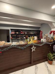 a lobby with a counter with food and drinks at Bernotiškių Hotel & Dining 