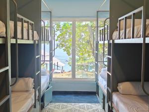 a room with bunk beds with a window at Beachside in Anjuna +39 photos