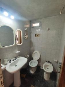 a bathroom with a sink and a toilet and a mirror at Rincón del Rio San Antonio in San Antonio de Arredondo +11 photos