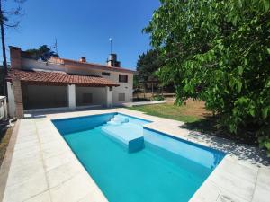 a swimming pool in front of a house at Rincón del Rio San Antonio in San Antonio de Arredondo