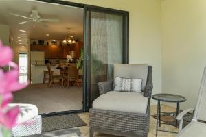 a living room with a chair and a table at Maui Kamaole K104 in Wailea