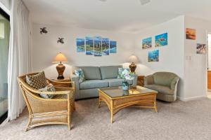 a living room with a couch and chairs and a table at Maui Kamaole K104 in Wailea +49 photos
