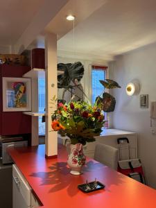 a kitchen with a table with a vase of flowers on it at Red Flat Paris in Paris