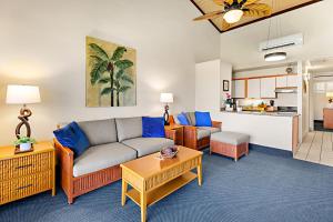 a living room with a couch and a table at Napili Shores H263 in Kapalua +30 photos