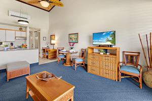 a living room filled with furniture and a flat screen tv at Napili Shores H263 in Kapalua