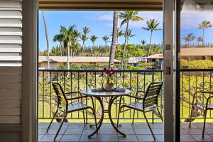 a patio with a table and chairs on a balcony at Napili Shores H263 in Kapalua