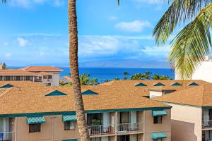 a view of a hotel with palm trees and the ocean at Maui Vista 3403 in Kihei