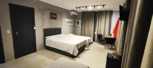 En eller flere senge i et værelse på Portal suítes Avenida Paraty