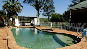 a swimming pool with a swing in a backyard at Lochinvar House in Lochinvar