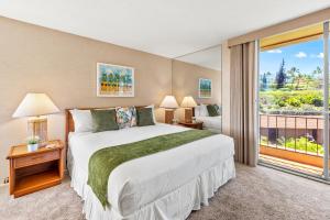 a bedroom with a large bed and a balcony at Maui Kaanapali Villas A414 in Kaanapali