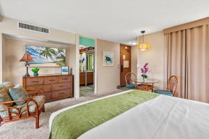 a hotel room with a bed and a table and chairs at Maui Kaanapali Villas A414 in Kaanapali