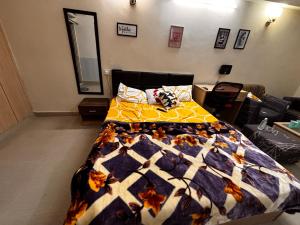 a bedroom with a bed with a quilt on it at The night view in Noida
