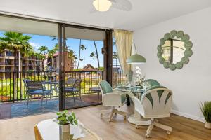 a living room with a table and chairs and a balcony at Papakea C209 in Honokowai +25 photos