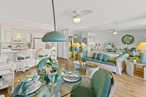 a living room with a couch and a table at Papakea C209 in Honokowai