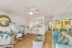 a living room with a couch and a dining room at Papakea C209 in Honokowai
