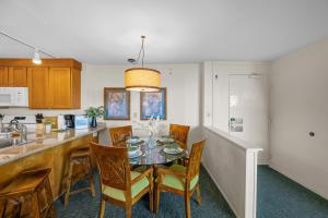 a kitchen with a table and chairs in a kitchen at Kaanapali Shores 512 in Kaanapali