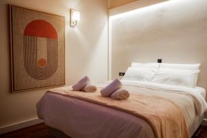 a hotel room with a bed with towels on it at Tollmere Hospitality Λύχνος suite in Livadeia