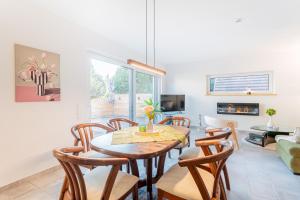 a living room with a dining room table and chairs at Sund Huus in Altefähr +22 photos