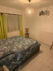 a bedroom with a bed and a pendant light at Petite maison au coeur des Hautes-Alpes in Aspres-sur-Buëch