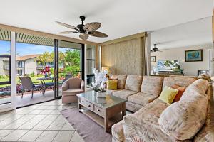 a living room with a couch and a table at Mahina Surf 117 in Honokowai