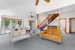 a living room with two chairs and a table at Adventures on the Bay - Bayfront Escape, Private Dock, Large Deck, and Lake Views! in Hudgins