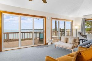a living room with a view of the ocean at Adventures on the Bay - Bayfront Escape, Private Dock, Large Deck, and Lake Views! in Hudgins +54 photos