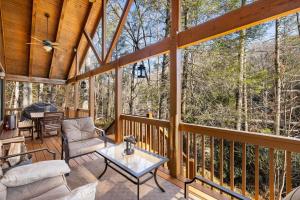 a screened in porch with a view of the woods at Maple Gap Cabins - 66 Acre Nature Retreat with TWO Charming Cabins in Brevard
