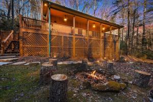 a house with a fire pit in front of it at Maple Gap Cabins - 66 Acre Nature Retreat with TWO Charming Cabins in Brevard